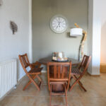 A wall clock above of the Dining table.